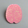Closeup view of a pink brain-shaped acrylic brooch