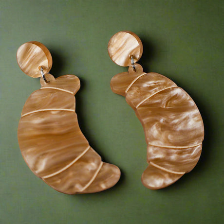 Pair of brown marbled croissant earrings with matching round toppers on a grey background