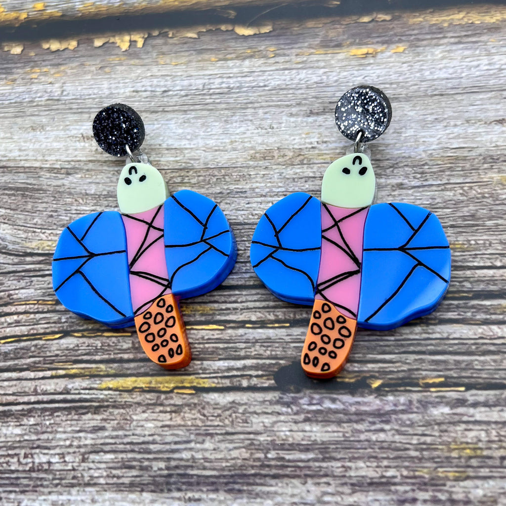 Acrylic dragonfly earrings in the style of a small child's drawing. Laser cut from acrylic.