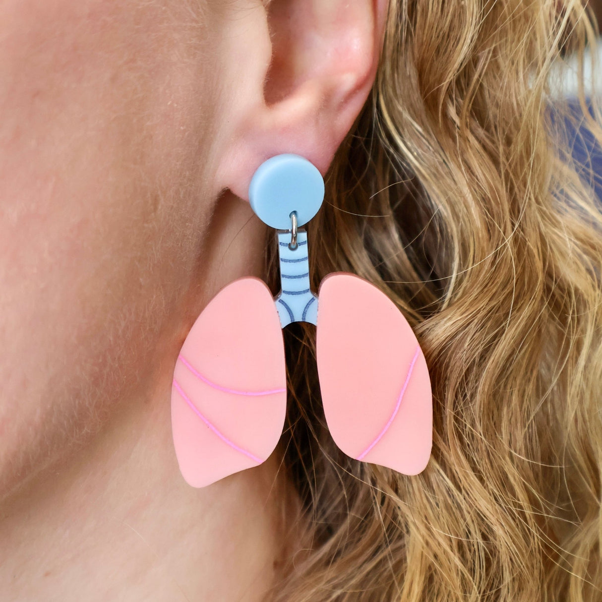 Anatomical lung earrings being modelled, Laser cut and handmade from acrylic.