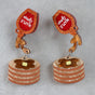 Earrings with pancake and syrup design on a gray background