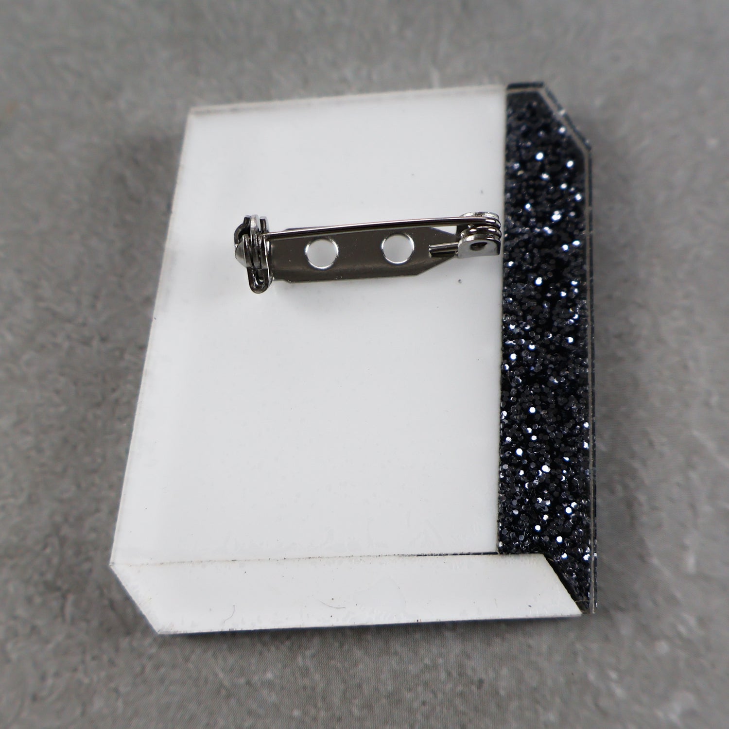 Book brooch back showing stainless steel brooch pin
