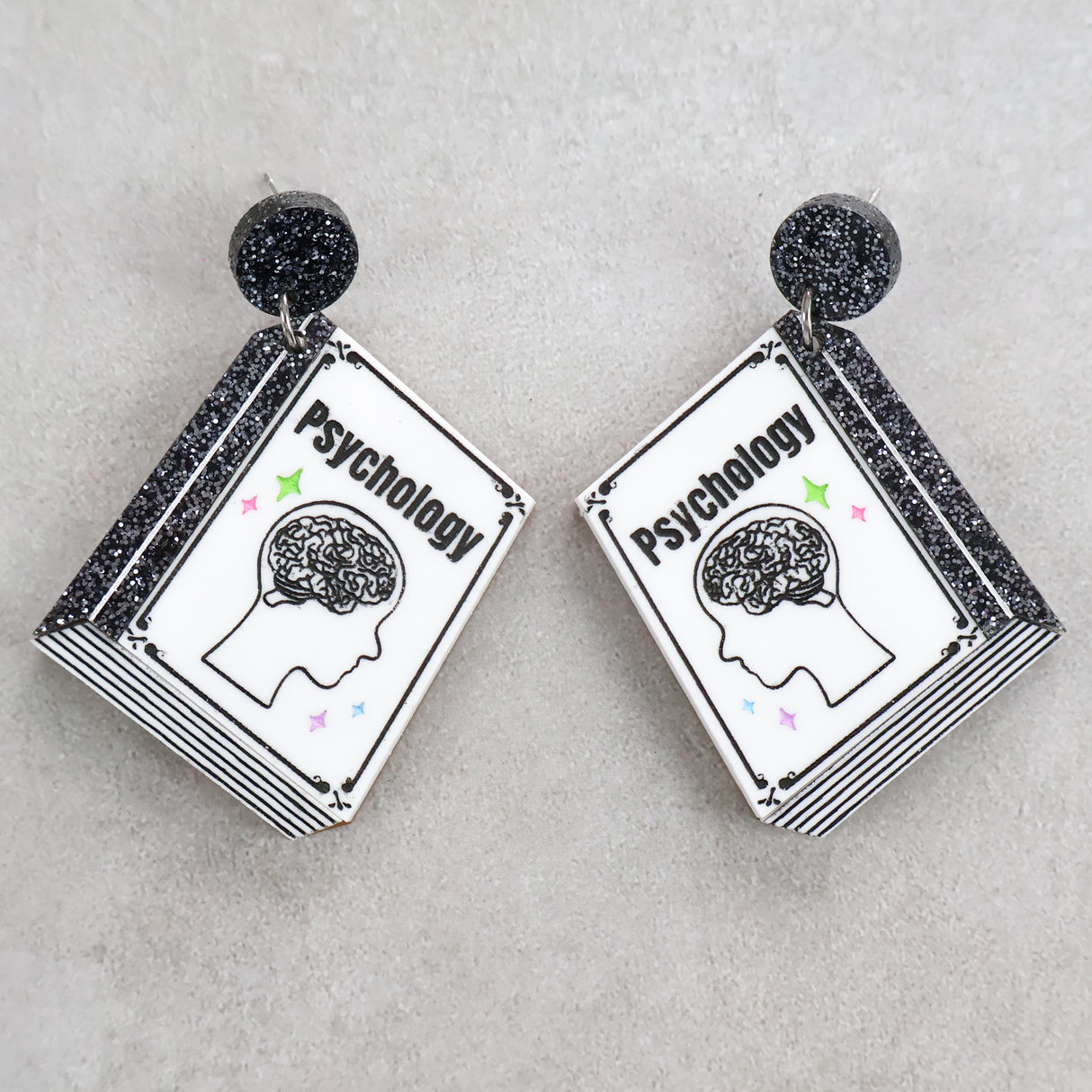 Book shaped acrylic earrings with 'Psychology' title.