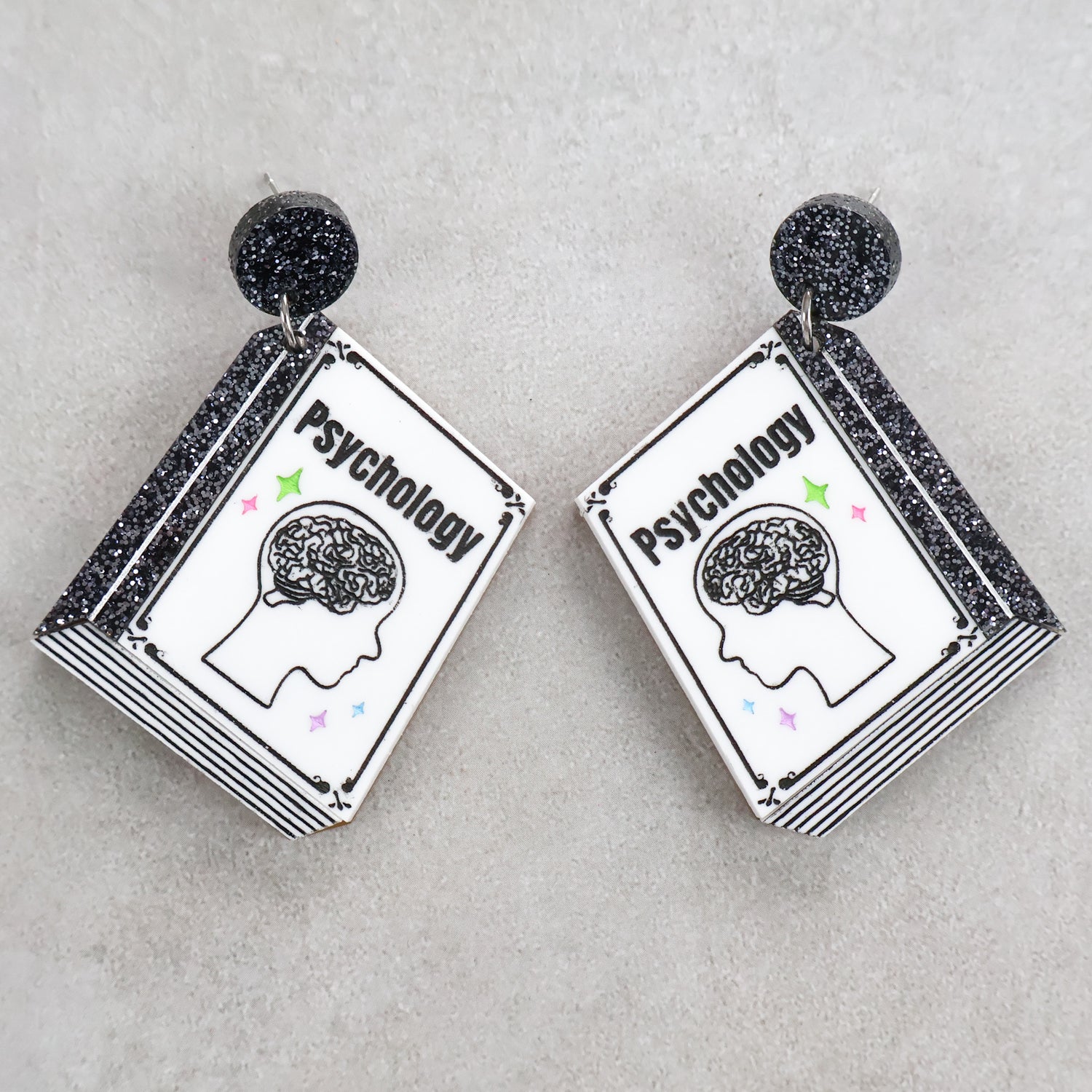 Book shaped acrylic earrings with 'Psychology' title.