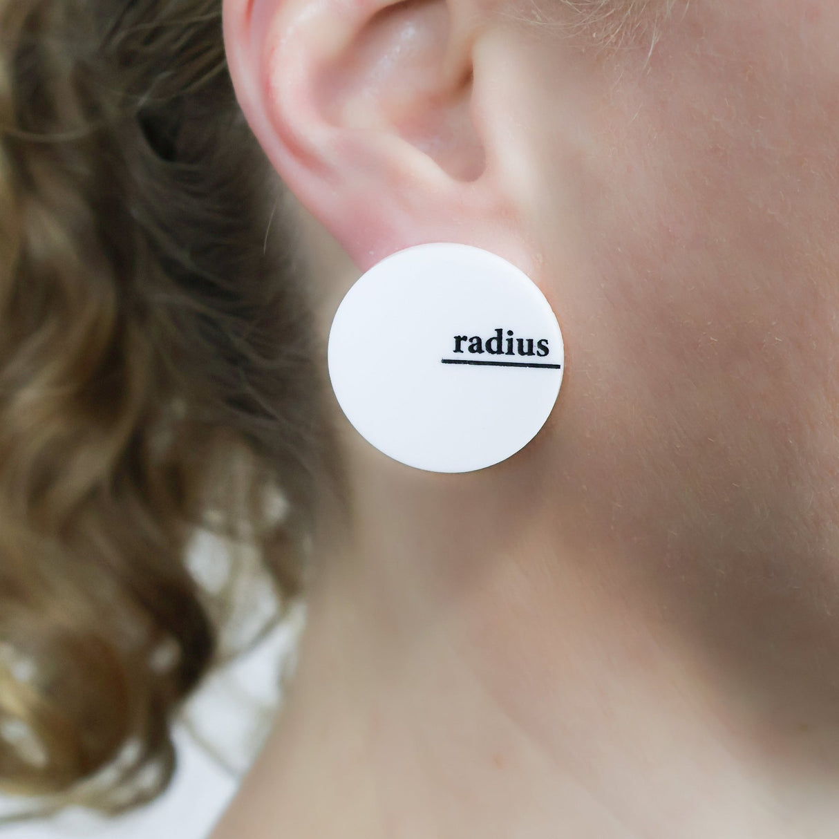White asymmetrical acrylic studs with radius and diameter engraved and handpainted in black. Being modelled.