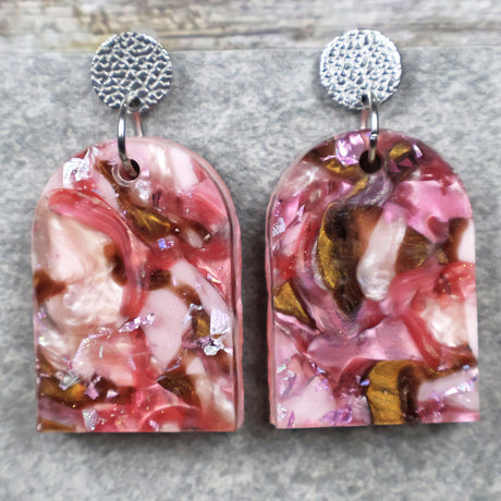 A pair of one of a kind arch shaped recycled acrylic earrings with pink and brown acrylics titled  'Dusky Petals' and stainless steel toppers. Pair 101-05