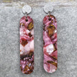 A pair of one of a kind long oval shaped recycled acrylic earrings with pink and brown acrylics titled  'Dusky Petals' and stainless steel toppers. Pair 101-11