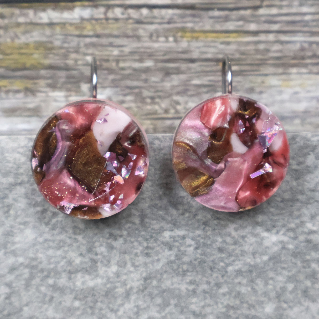 A pair of one of a kind round recycled acrylic earrings with stainless steel french hooks and pink and brown acrylics titled  'Dusky Petals'. Pair 101-15
