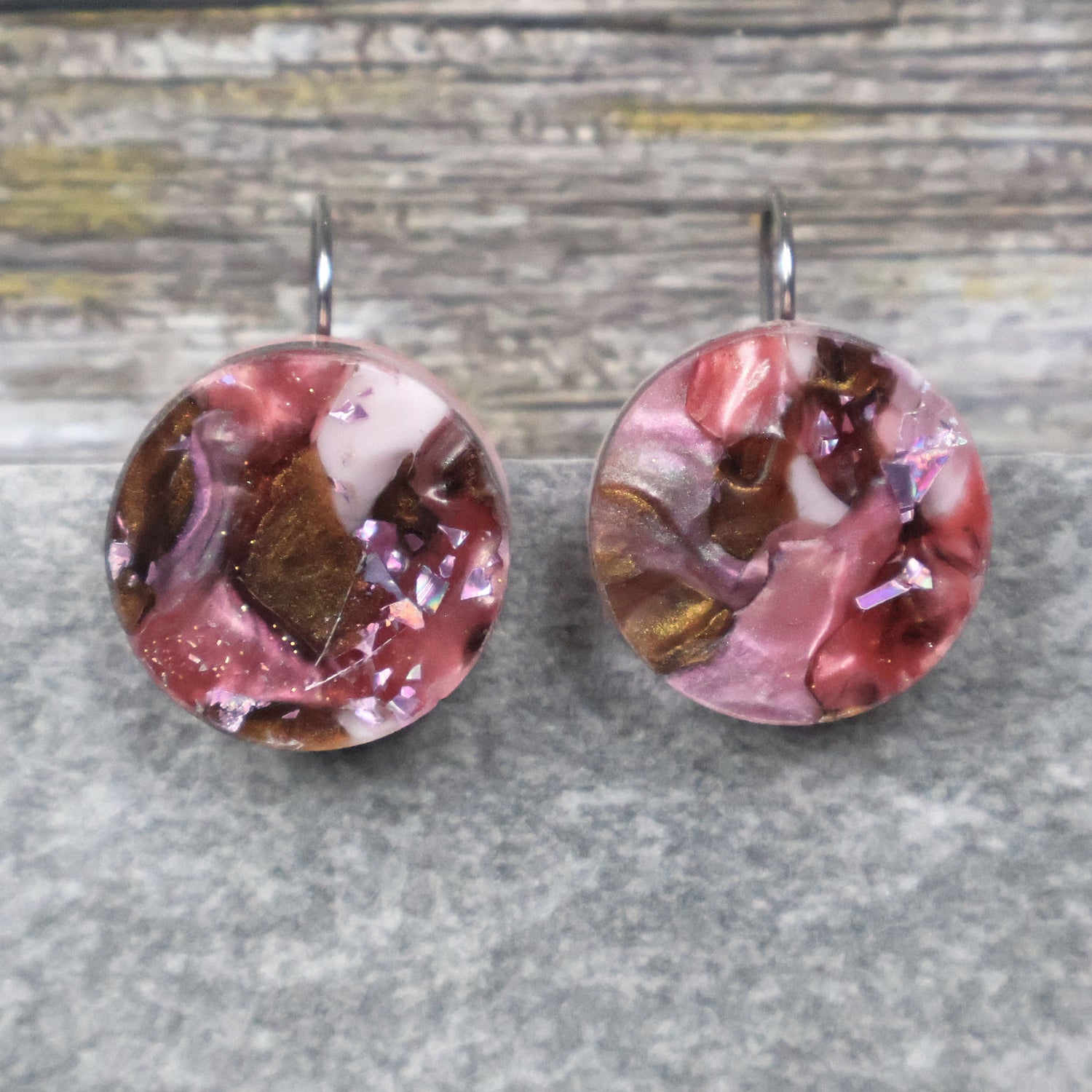 A pair of one of a kind round recycled acrylic earrings with stainless steel french hooks and pink and brown acrylics titled  'Dusky Petals'. Pair 101-15