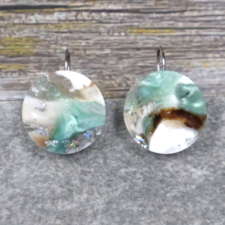 A pair of one of a kind round recycled acrylic earrings with stainless steel french hooks and silver, green and brown design titled 'Celestial Tide' Pair 106-17