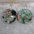 A pair of one of a kind disc shaped recycled acrylic earrings on stainless steel hoops with green and pink acrylics titled 'Enchanted Forest'. Pair 03-10