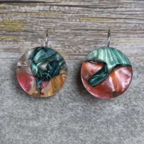 A pair of one of a kind round recycled acrylic earrings with stainless steel french hooks and multicolored design titled 'Sunset Reef'. Pair 106-115