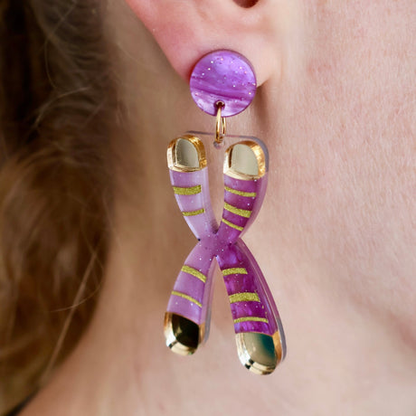 Chromosome Earrings styled on a model’s earlobe to showcase scale, sparkle finish, and handcrafted quality