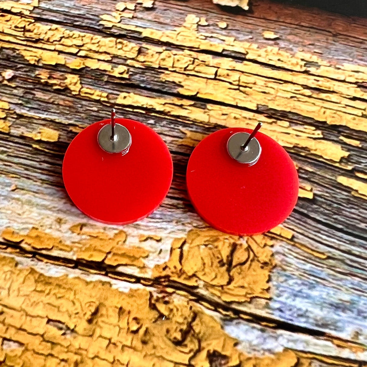 back view of red blood cell stud earrings showing red acrylic and stainless steel earring posts.