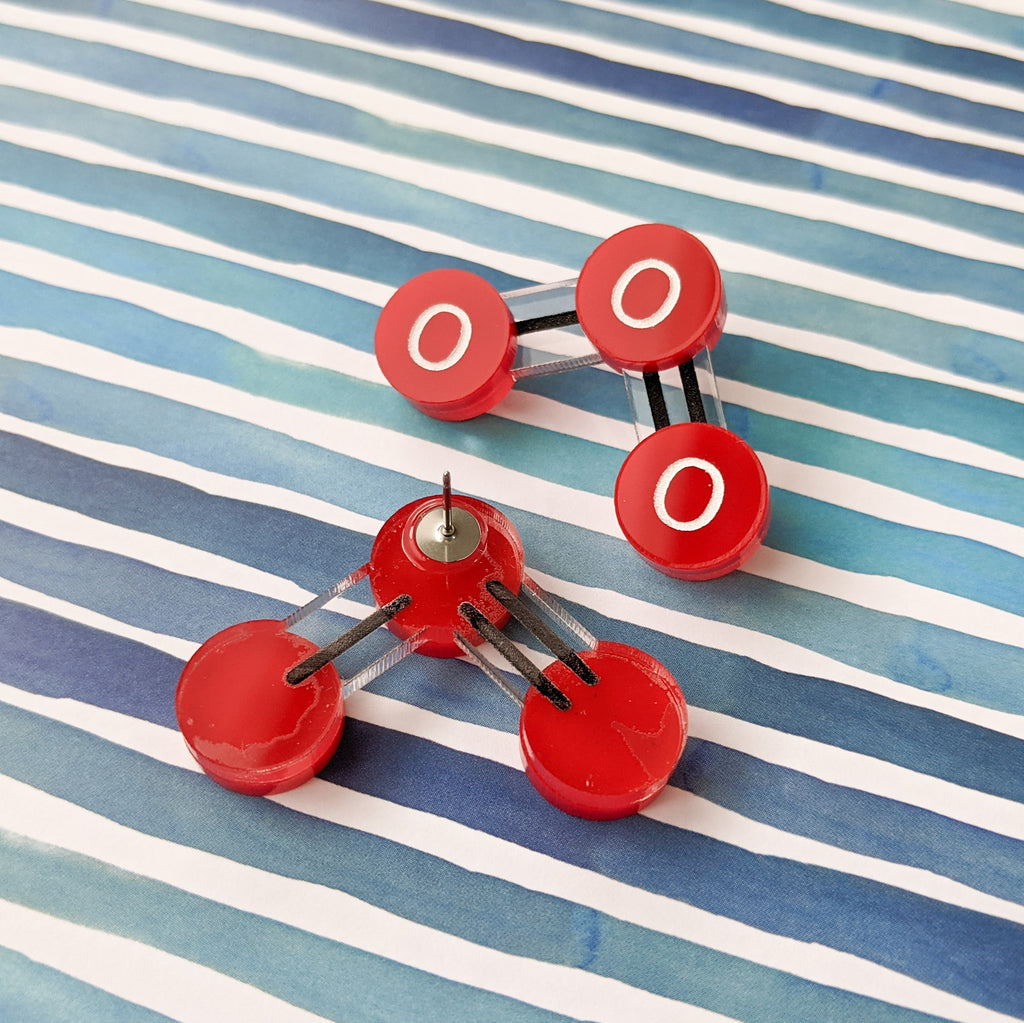 Laser cut acrylic ozone molecule studs, with red oxygen atoms and black molecular bonds. Back earring view showing the stainless steel earring post.