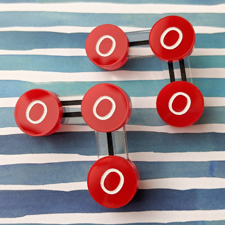 Laser cut acrylic ozone molecule studs, with red oxygen atoms and black molecular bonds.