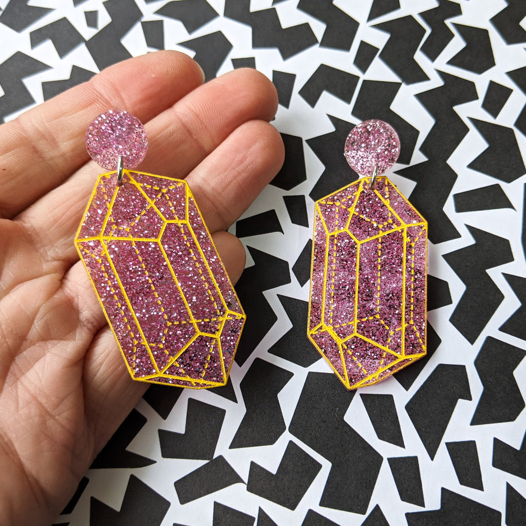 Pink glitter crysalline structure earrings with yellow handpainted outlines of the crystal structure.  Second view.