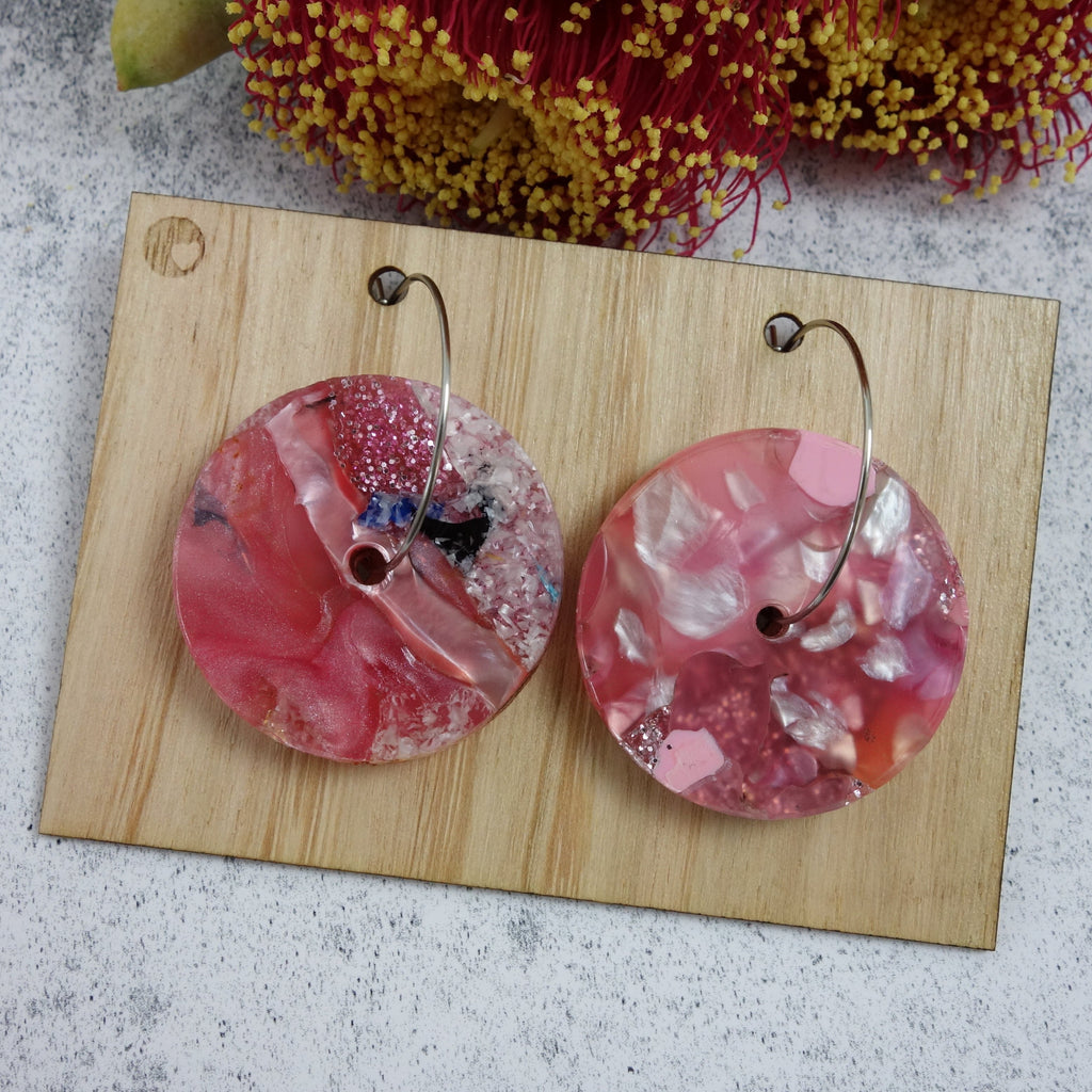 Disc shaped one-of-a-kind recycled acrylic earrings with stainless steel hoops