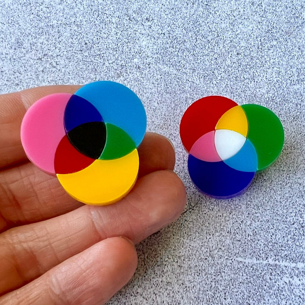 A pair of small subtractive and additive colour wheel brooches, laser cut in acrylic.