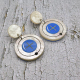 Hydrogen atom dangle earrings made from laser cut acrylic. Closeup.