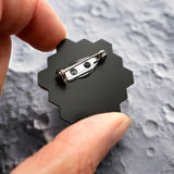 The back of the JWST mini brooch showing the stainless steel brooch pin