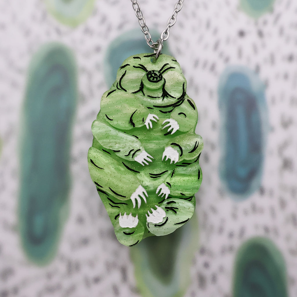 Front on view of green acrylic tardigrade pendant