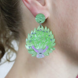 Laser cut acrylic leaf sheep earrings, being modelled.