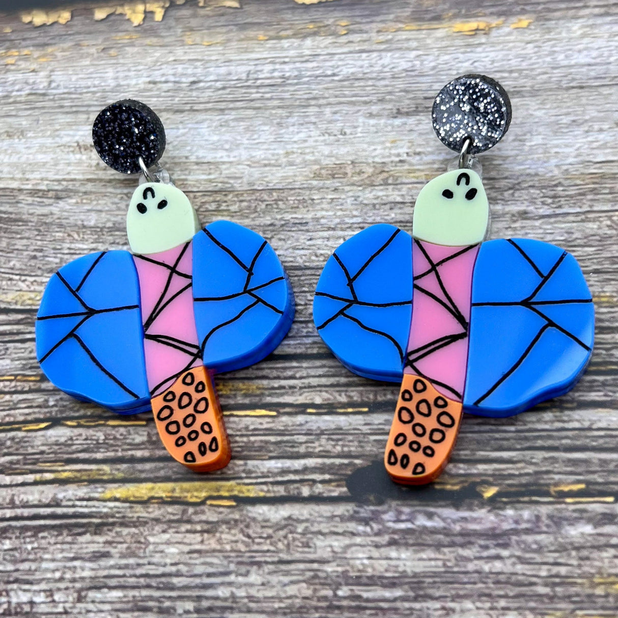 Acrylic dragonfly earrings in the style of a small child's drawing. Laser cut from acrylic.