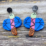 Acrylic dragonfly earrings in the style of a small child's drawing. Laser cut from acrylic.