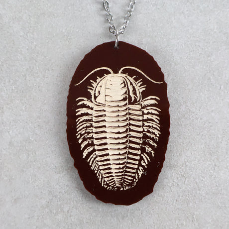 Brown acrylic pendant with trilobite design and stainless steel chain. 