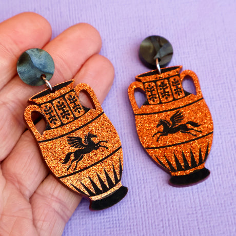 Amphora jar earrings in hand