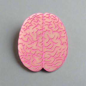 Closeup view of a pink brain-shaped acrylic brooch