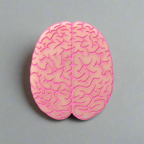 Closeup view of a pink brain-shaped acrylic brooch