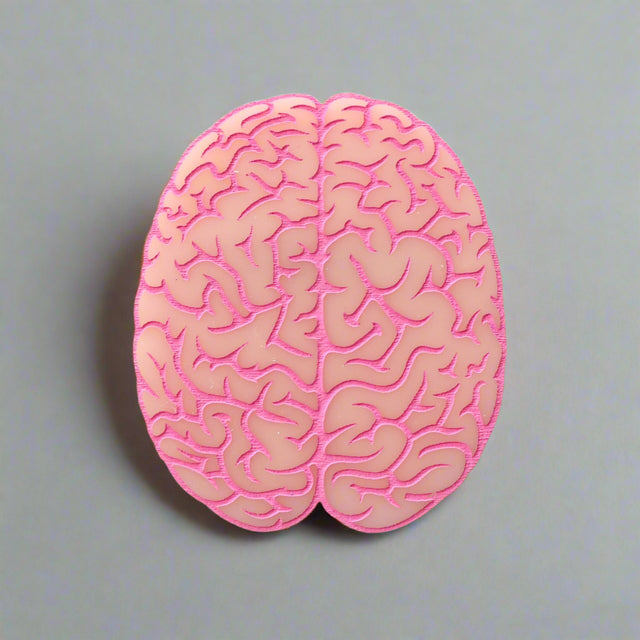 Closeup view of a pink brain-shaped acrylic brooch
