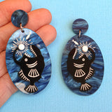 Anglerfish earrings in hand