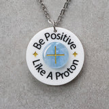 Necklace with a pendant that says 'Be Positive Like A Proton'