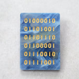 Blue rectangular acrylic brooch with gold binary code  reading 'binary'