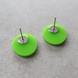 Back view of green biohazard studs showing stainless steel earring posts. 
