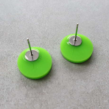 Back view of green biohazard studs showing stainless steel earring posts. 