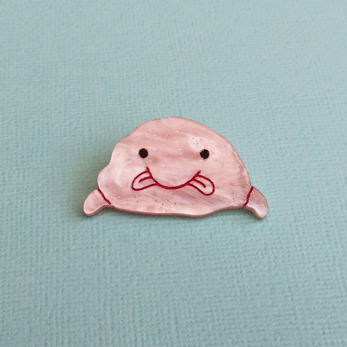 Acrylic pink blobfish brooch closeup