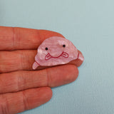 Closeup of acrylic Blobfish brooch in hand