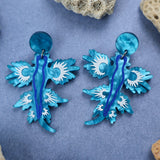 Laser cut blue sea dragon earrings, closeup. 