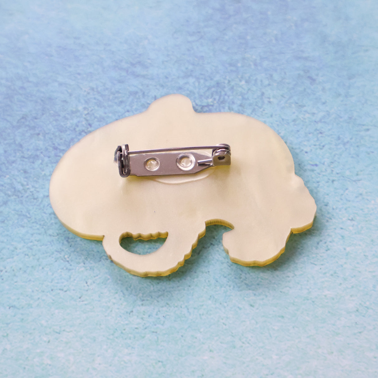 Back view of a blue ringed octopus acrylic brooch showing stainless steel brooch pin with rolling clasp