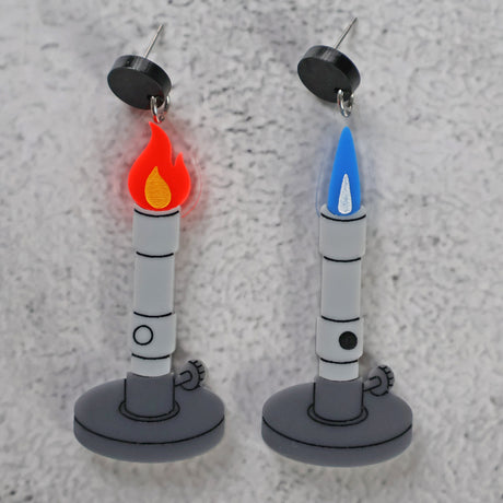 Asymmetrical Bunsen burner earrings with red and blue flame design against a textured background.