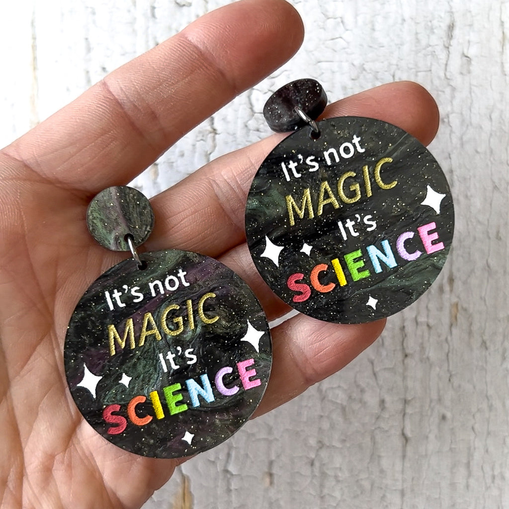 Round dangle earrings with "It's not Magic It's Science' engraved and handpainted within. Made from laser cut swirly acrylic.