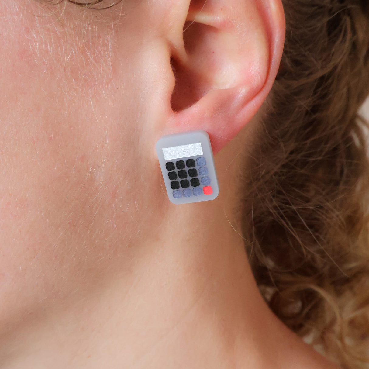 Small grey acrylic calculator studs being modelled