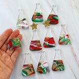 Photo showing the variation in colours across different pairs of dangle earrings featuring a conical flask design with Christmas-themed decorations.