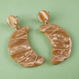Pair of brown marbled croissant earrings with matching round toppers on a grey background