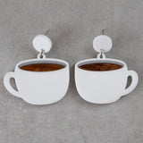 White coffee cup earrings with brown center and white round toppers on a grey background