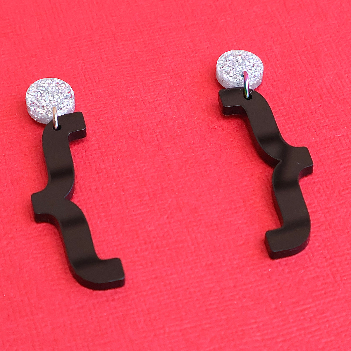 Curly bracket earrings angled view